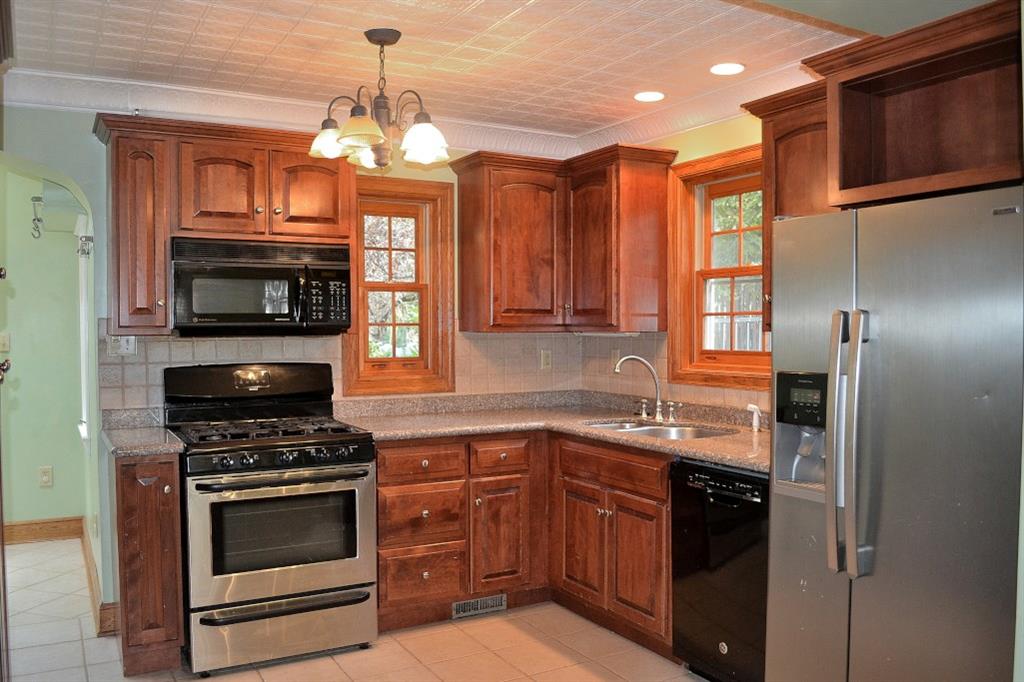 138 Siebert Road Pittsburgh, PA 15237 - Photo 9 of 25 The stove is a five-burner gas stove. The double bowl sink has a garbage disposal. The open cabinet above the refrigerator is a nice display case or storage for cook books.