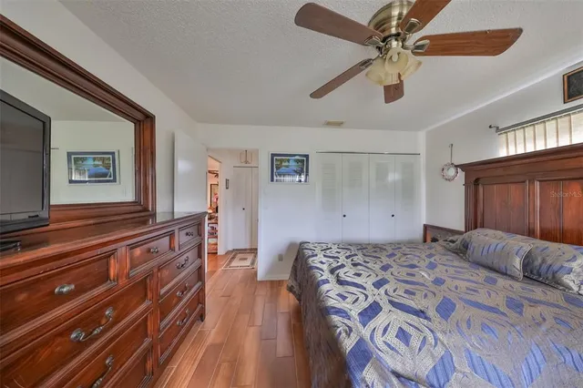 a bedroom with a large bed chandelier and a window