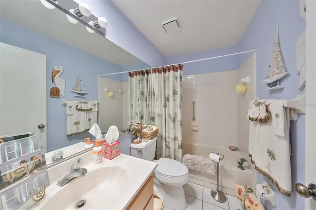 a bathroom with a sink toilet tub and shower