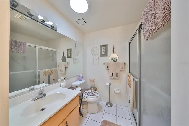 a spacious bathroom with a sink mirror toilet and shower