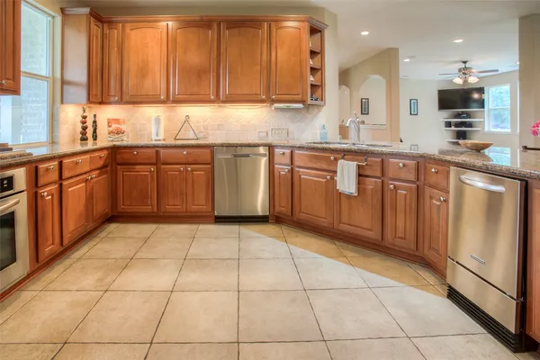 a kitchen with stainless steel appliances granite countertop a sink and cabinets