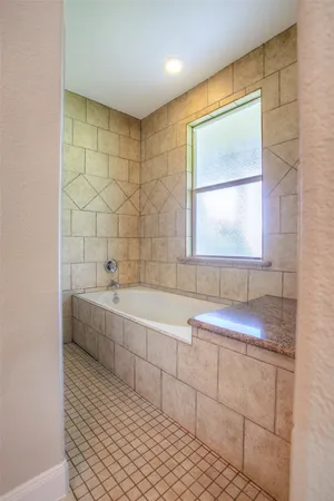 a bathroom with a bathtub and a sink