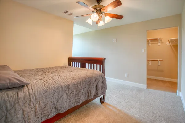 a bed sitting in a room next to a window