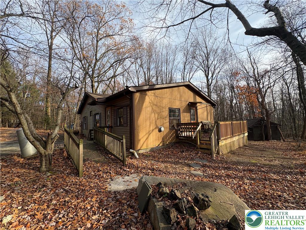 1433 Deer Path Drive Walnutport, PA 18088 - Photo 12 of 39 a view of backyard with large trees and wooden fence