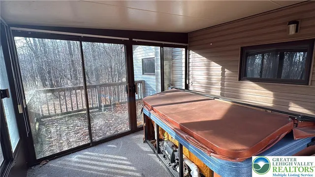 a view of an empty room with closet and a window