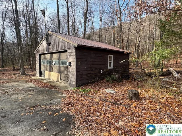 a backyard of a house with barbeque oven and outdoor seating