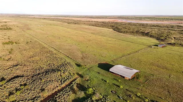 an aerial view of residential houses with outdoor and green space