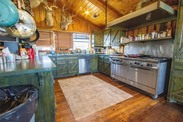 a view of a bedroom with a bed and wooden floor