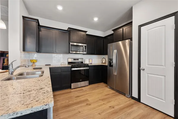a kitchen with granite countertop stainless steel appliances and wooden cabinets
