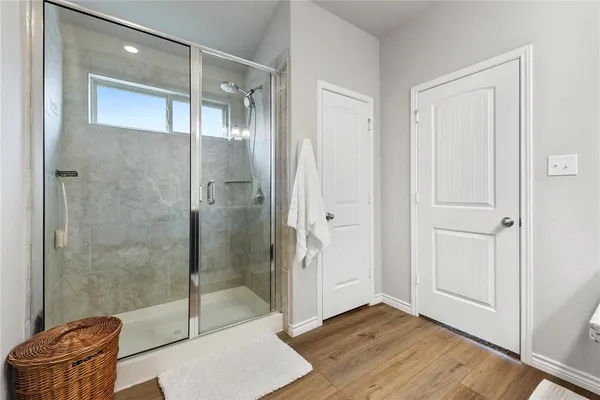 a bathroom with a glass shower door