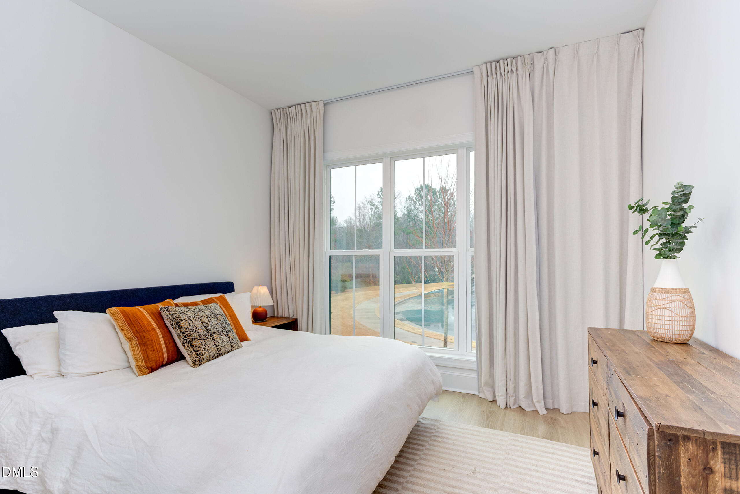 203 Post Oak Road Chapel Hill, NC 27516 - Photo 16 of 52 a bedroom with a large bed and a window