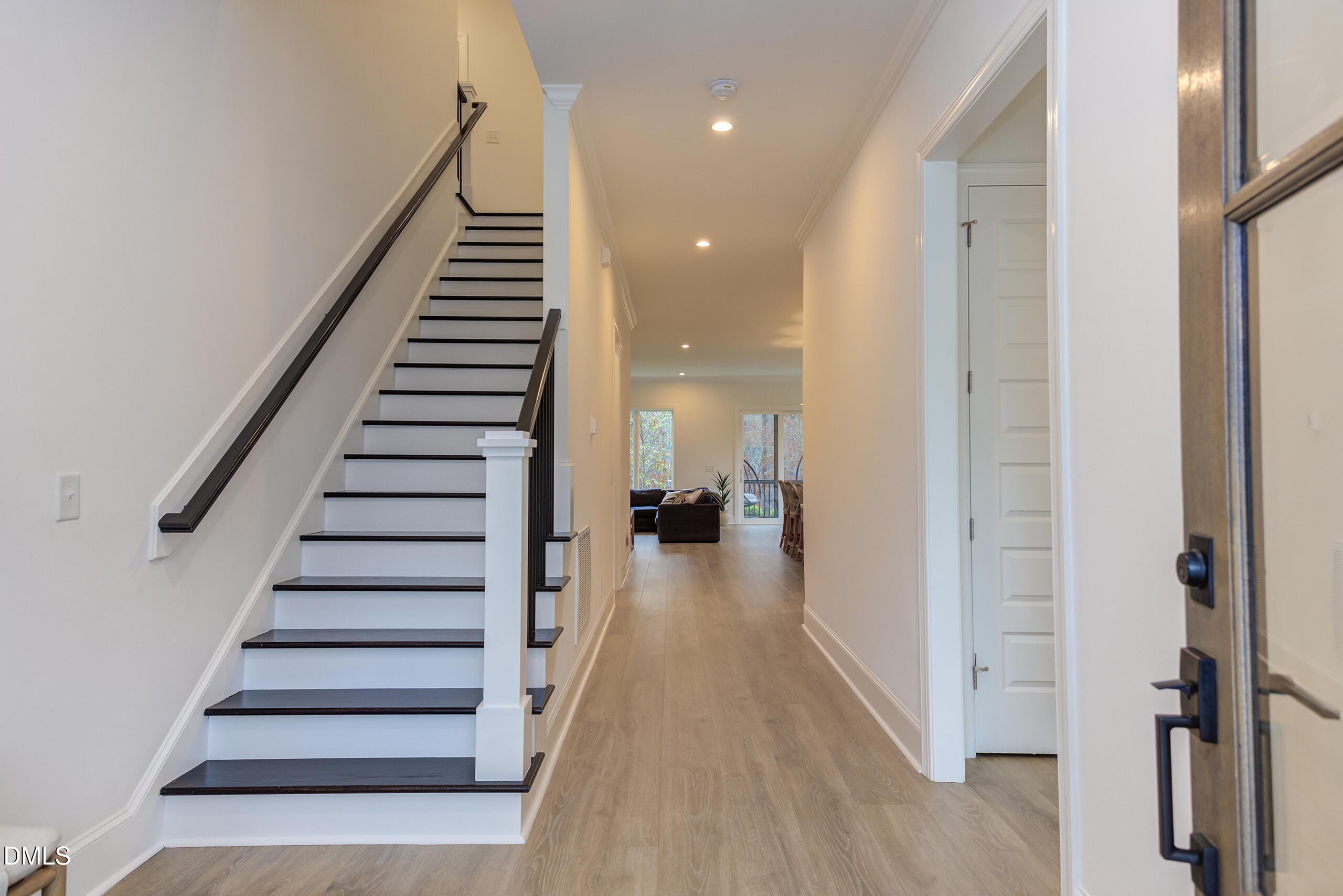 203 Post Oak Road Chapel Hill, NC 27516 - Photo 29 of 52 a view of a hallway with wooden floor and stairs
