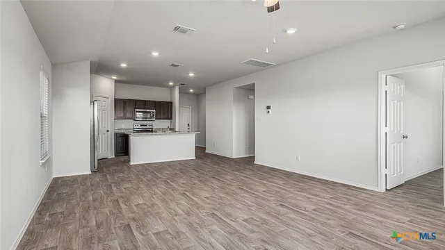 a view of kitchen with microwave and cabinets