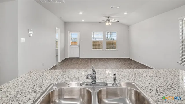 a view of a kitchen sink and natural light