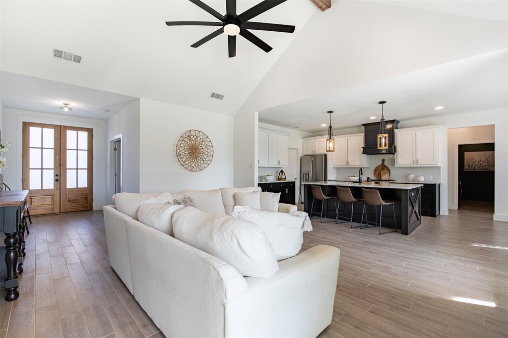 111 Bluegrass Trail Springtown, TX 76082 - Photo 12 of 37 Living room flows seamlessly to kitchen and dining areas.