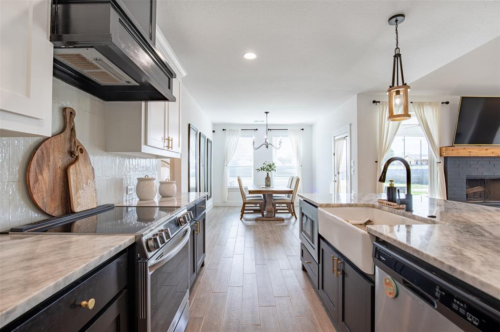 111 Bluegrass Trail Springtown, TX 76082 - Photo 16 of 37 Kitchen boasts stainless steel appliances and farm sink.