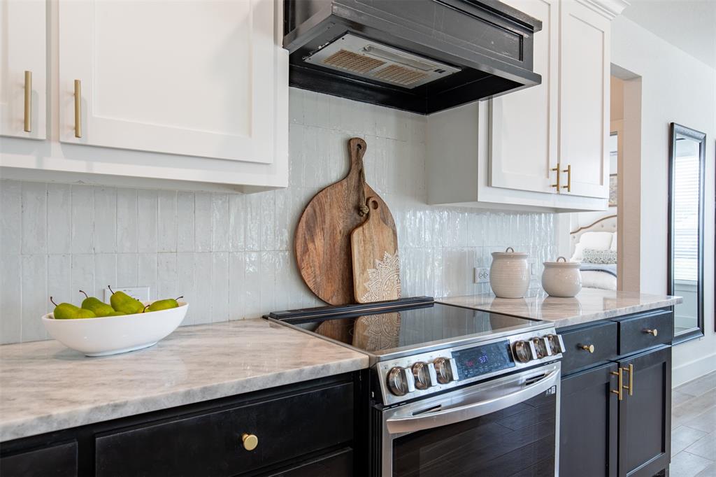 111 Bluegrass Trail Springtown, TX 76082 - Photo 17 of 37 Kitchen features designer backsplash and painted range hood.