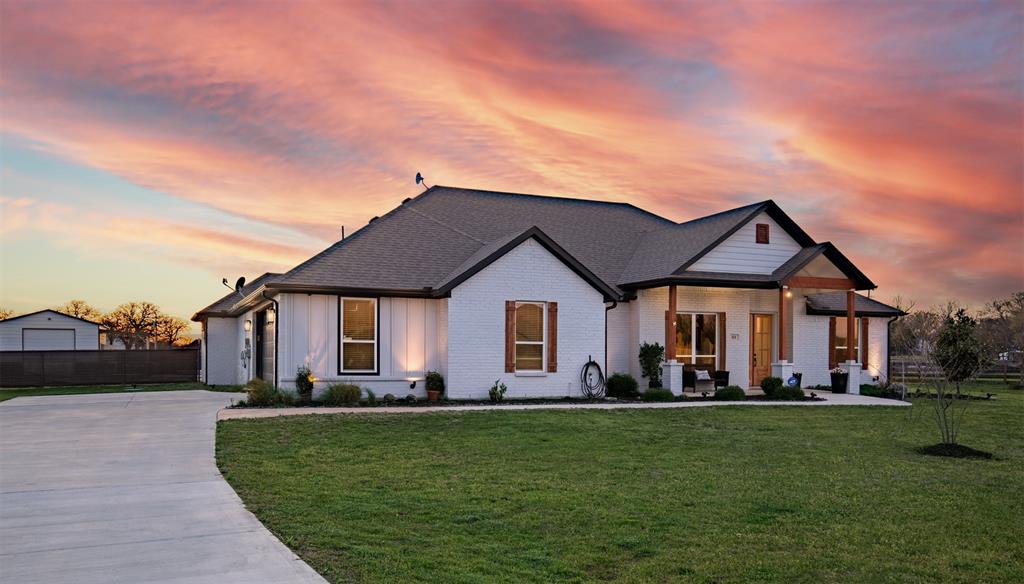 111 Bluegrass Trail Springtown, TX 76082 - Photo 2 of 37 Nestled nicely on over a 1 acre lot with side entry garage and generous driveway.