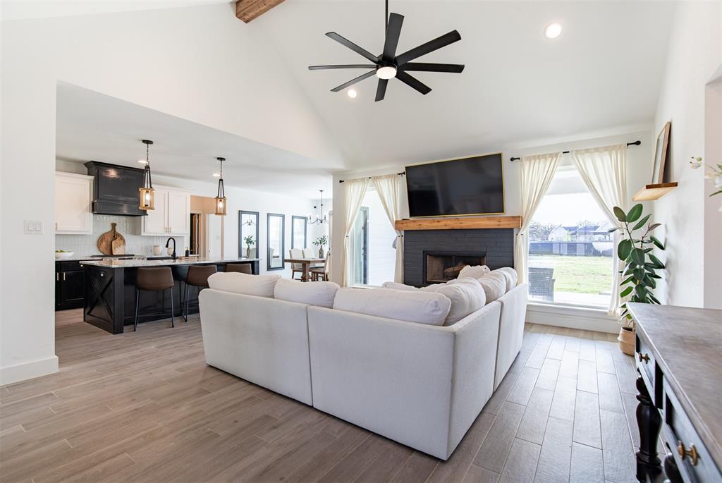 111 Bluegrass Trail Springtown, TX 76082 - Photo 9 of 37 Open-concept living room with vaulted ceiling with beam.