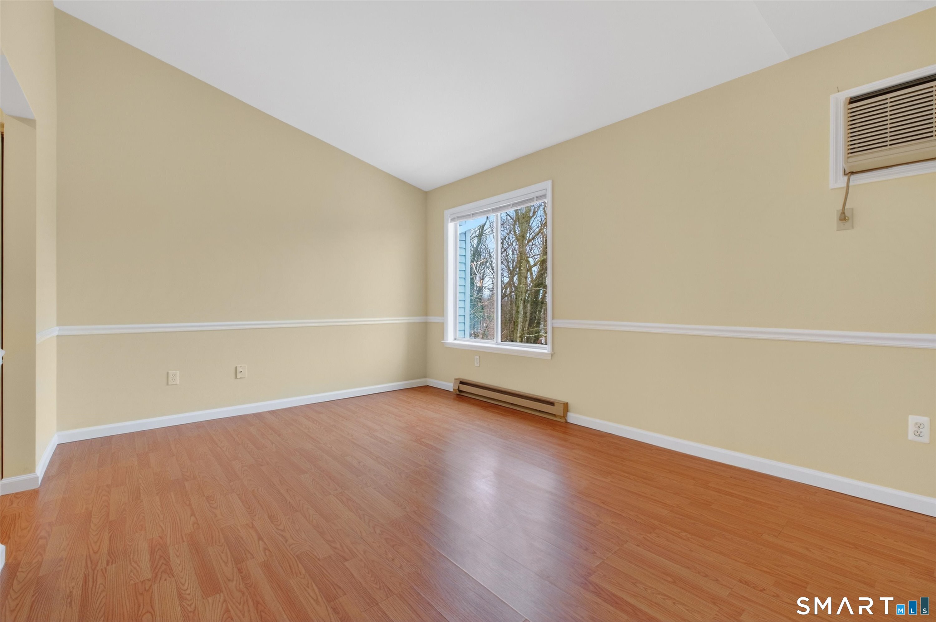20 East Pembroke Road, Unit 8 Danbury, CT 06811 - Photo 12 of 23 an empty room with wooden floor and windows