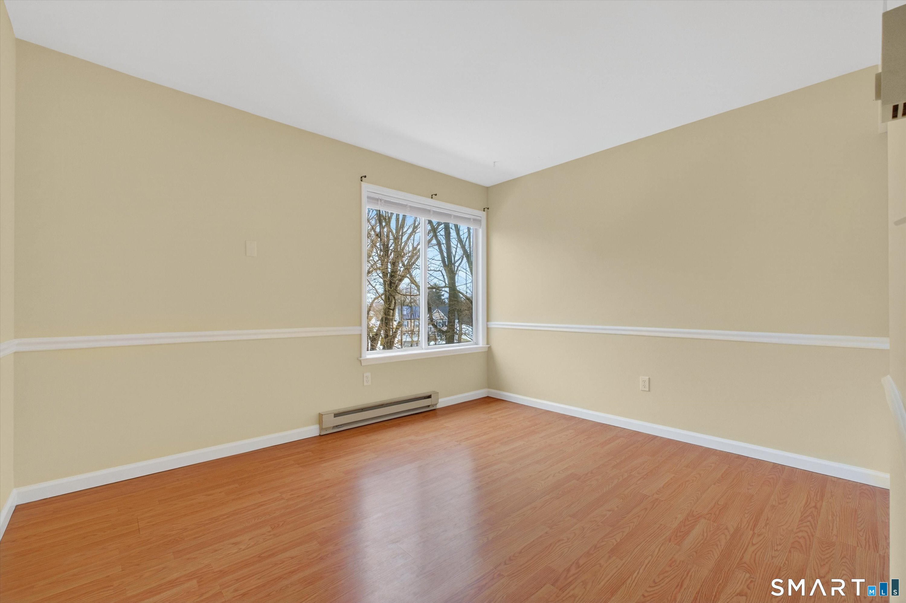 20 East Pembroke Road, Unit 8 Danbury, CT 06811 - Photo 16 of 23 a view of an empty room with wooden floor and a window