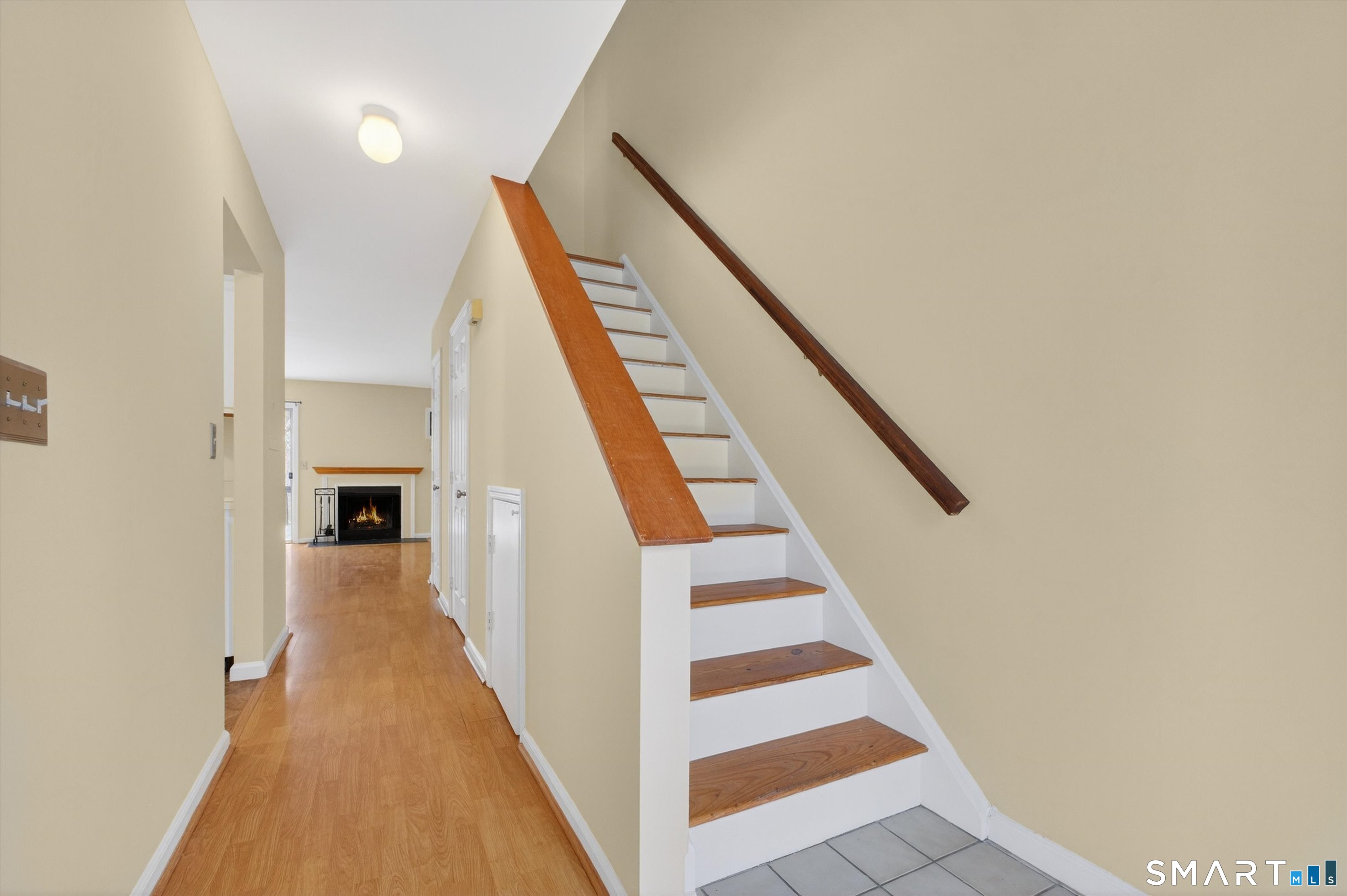 20 East Pembroke Road, Unit 8 Danbury, CT 06811 - Photo 4 of 23 a view of a hallway with wooden floor and staircase