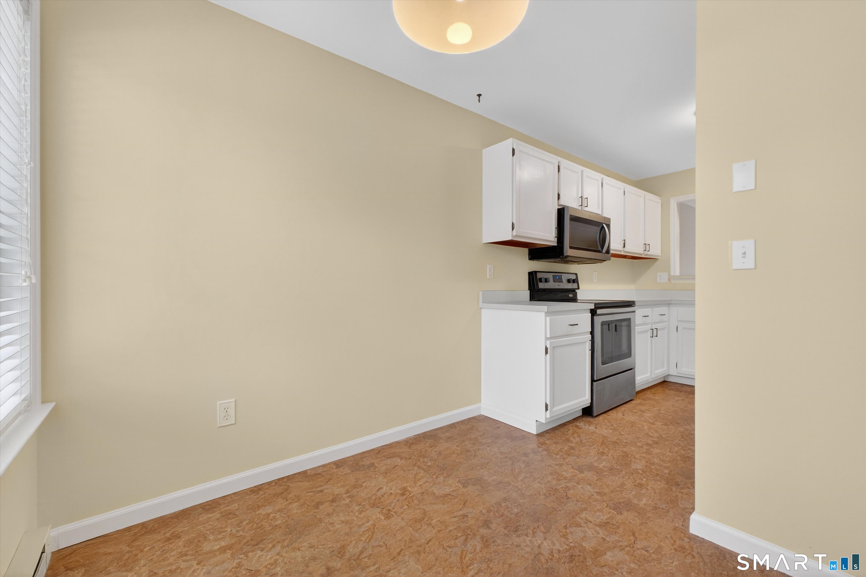 20 East Pembroke Road, Unit 8 Danbury, CT 06811 - Photo 6 of 23 a kitchen with white cabinets and a stove