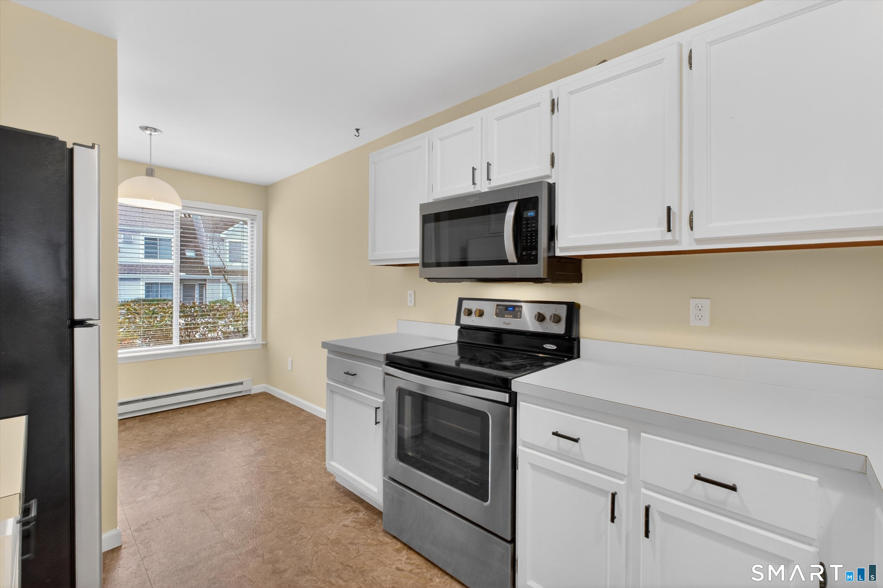 20 East Pembroke Road, Unit 8 Danbury, CT 06811 - Photo 8 of 23 a kitchen with stainless steel appliances white cabinets and a stove top oven