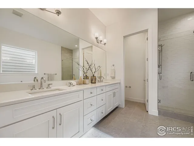 a bathroom with a granite countertop sink mirror and double