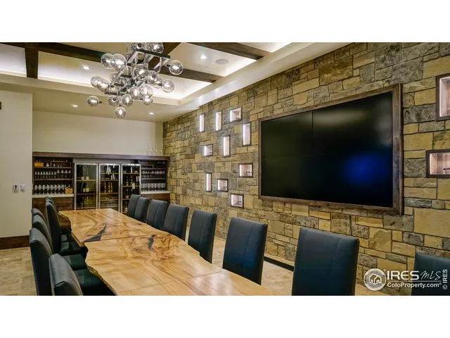 a living room with lots of furniture and a large window