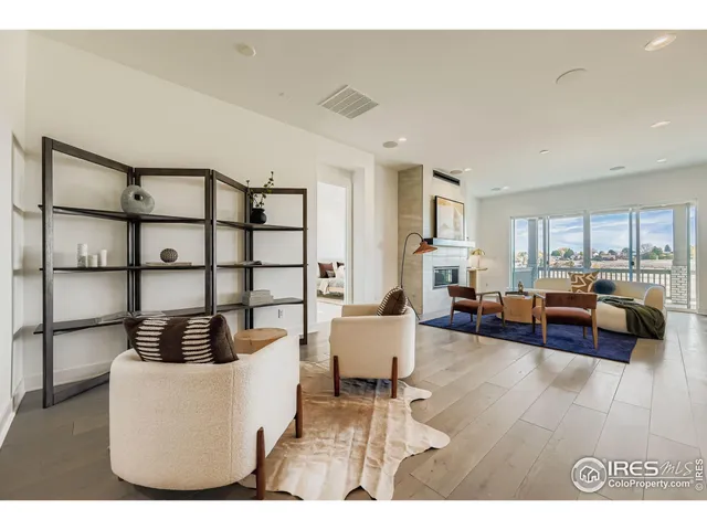 a living room with furniture and a book shelf