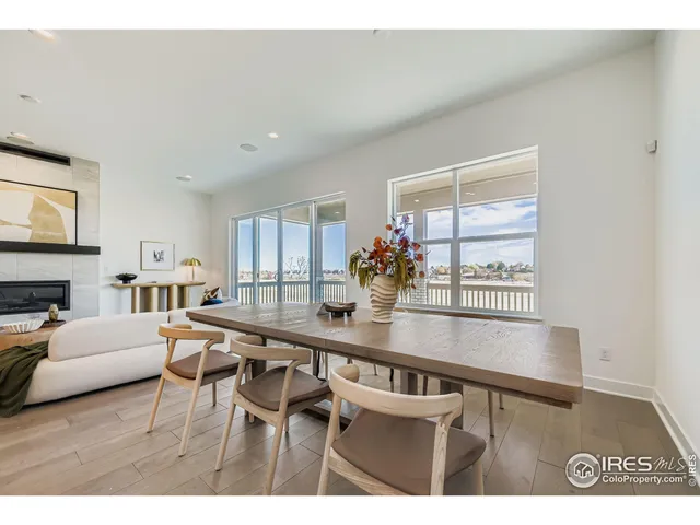 a living room with furniture a flat screen tv and a table