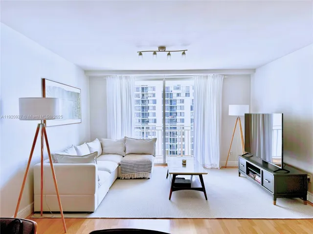 a living room with furniture rug and window