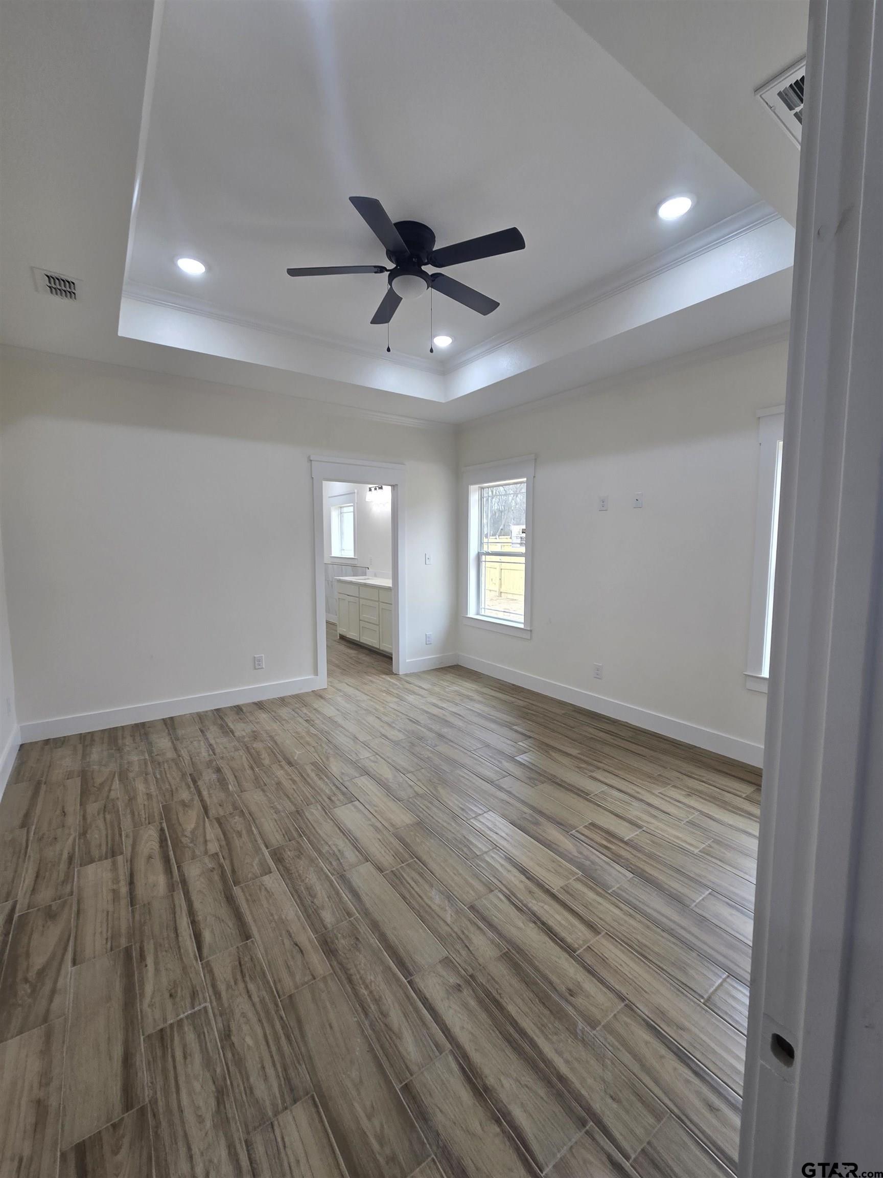 7227 Cr 485 Tyler Tx 75706 Tyler, TX 75706 - Photo 16 of 23 a view of empty room with wooden floor and fan
