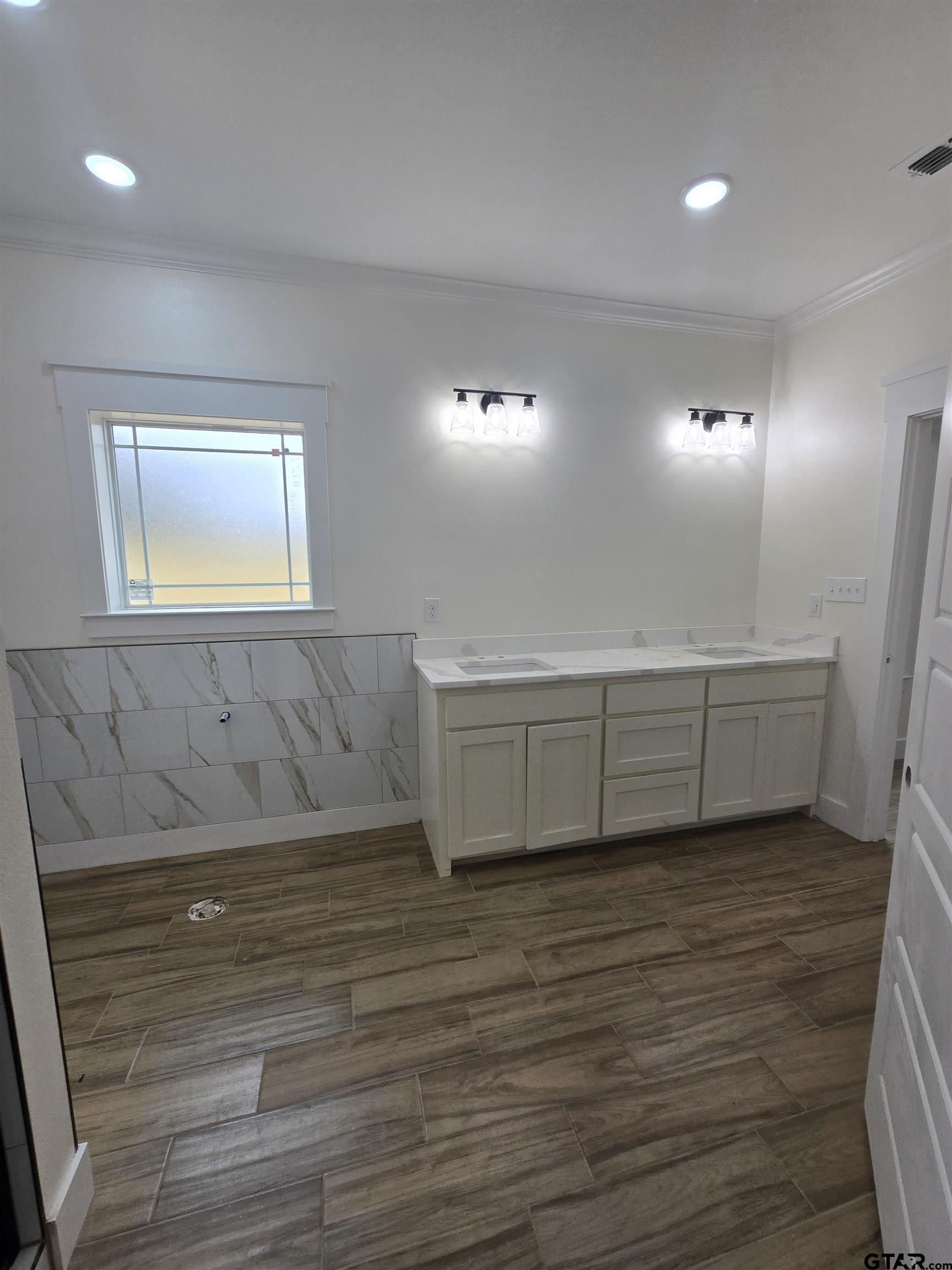7227 Cr 485 Tyler Tx 75706 Tyler, TX 75706 - Photo 17 of 23 a view of an empty room with wooden floor and a window