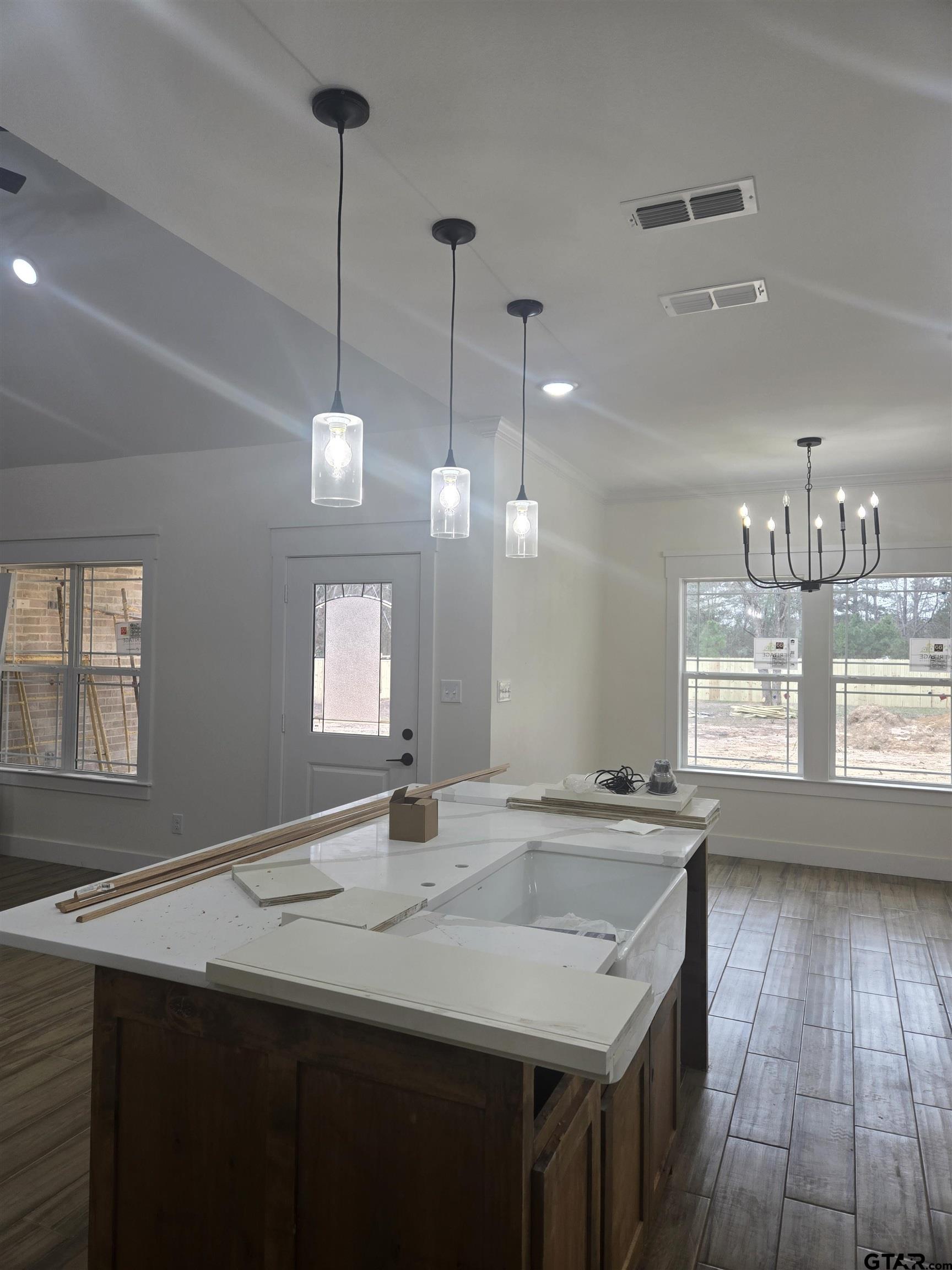 7227 Cr 485 Tyler Tx 75706 Tyler, TX 75706 - Photo 5 of 23 a kitchen with a sink a window and wooden floor