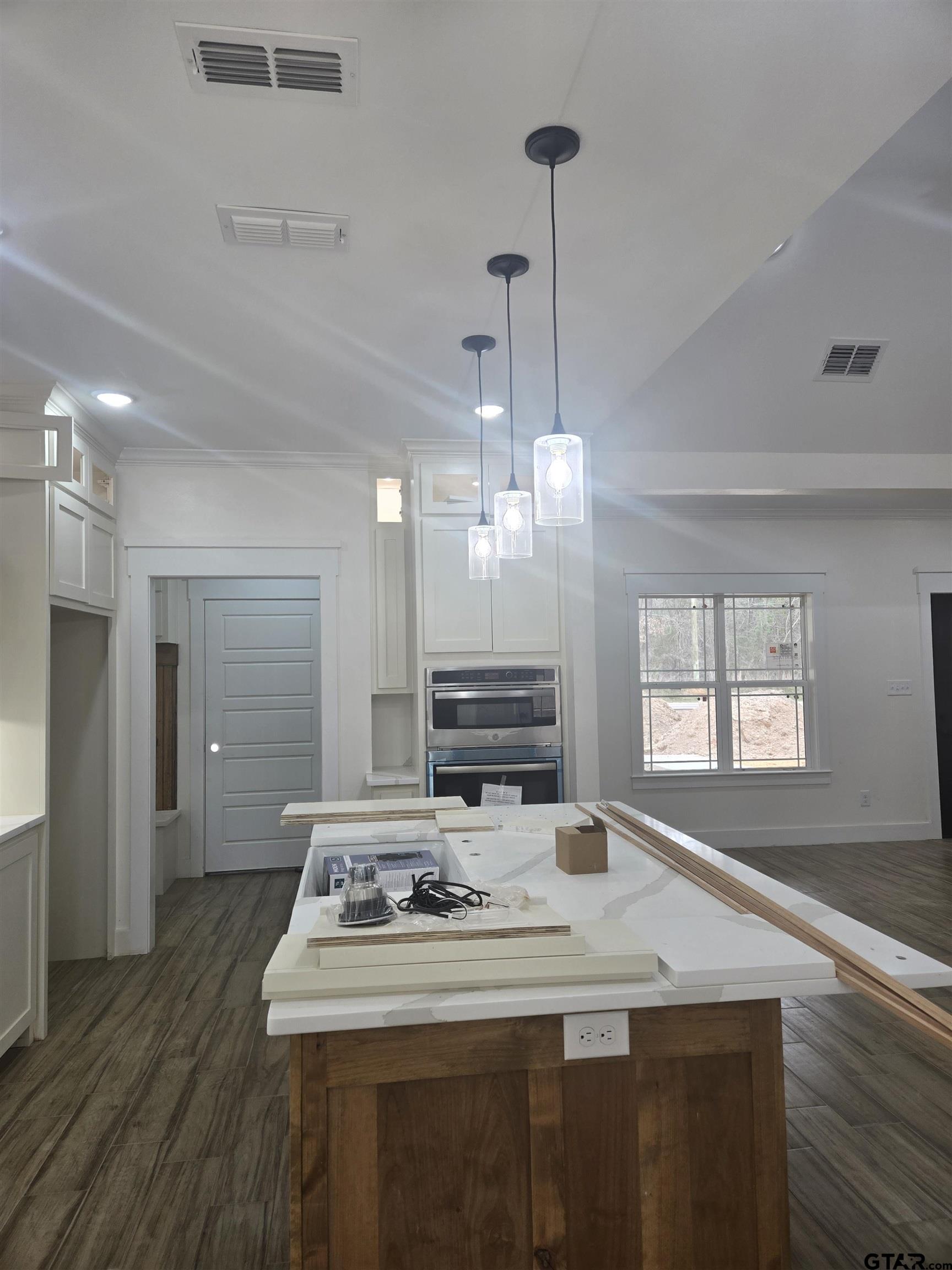 7227 Cr 485 Tyler Tx 75706 Tyler, TX 75706 - Photo 6 of 23 a kitchen with kitchen island white cabinets sink and refrigerator