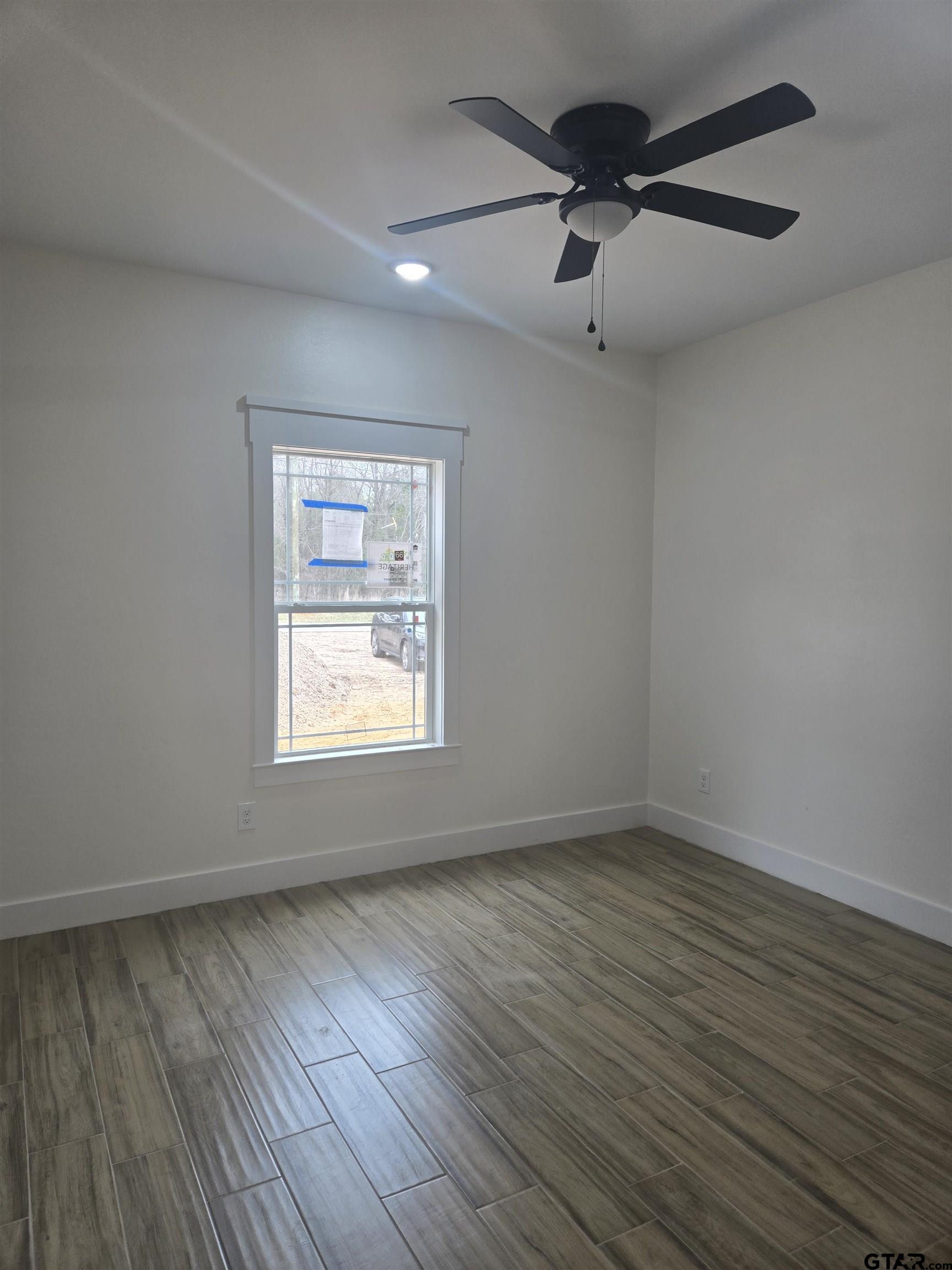 7227 Cr 485 Tyler Tx 75706 Tyler, TX 75706 - Photo 9 of 23 wooden floor in an empty room with a window