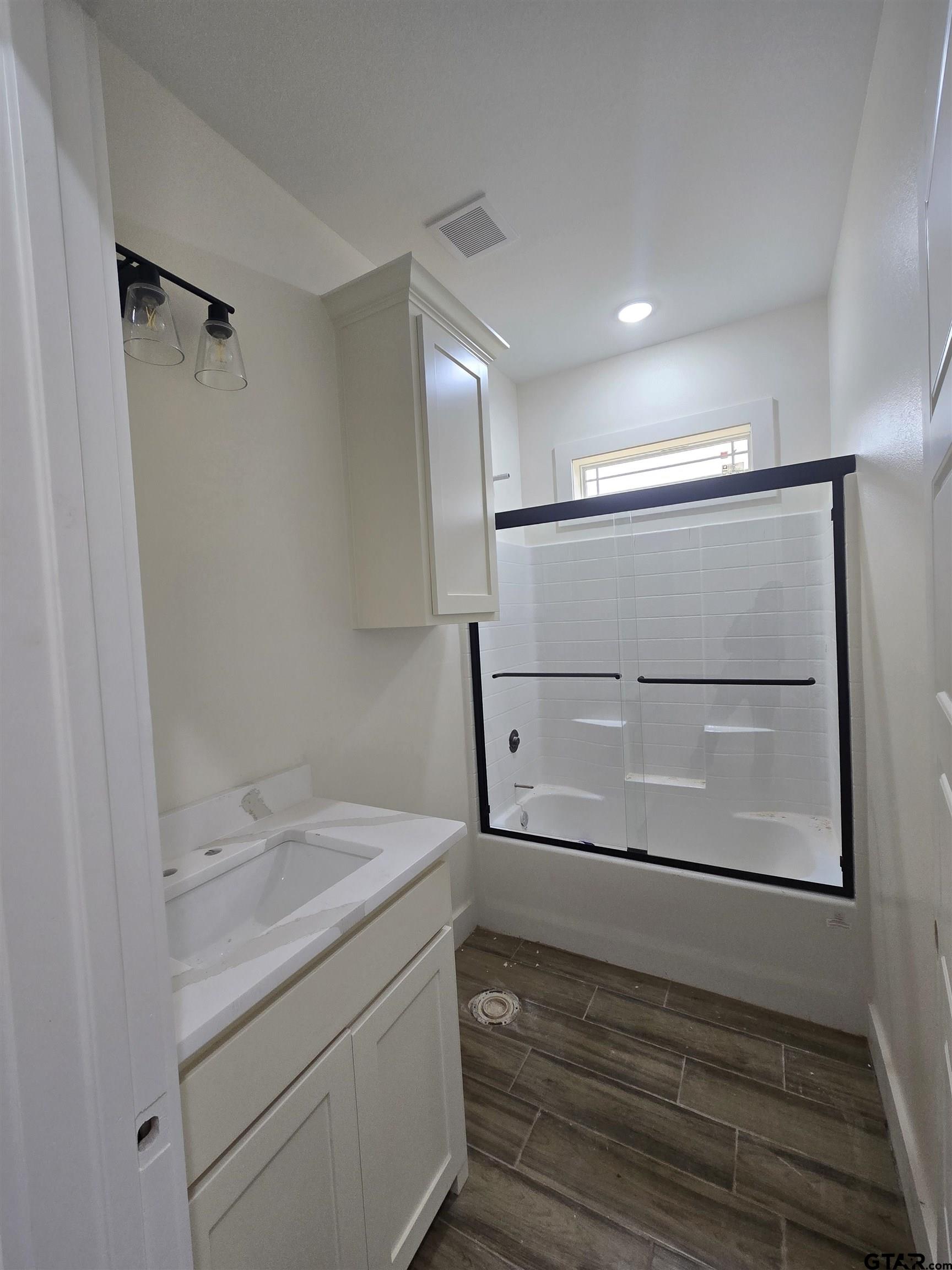 7227 Cr 485 Tyler Tx 75706 Tyler, TX 75706 - Photo 10 of 23 a bathroom with a sink a mirror and shower