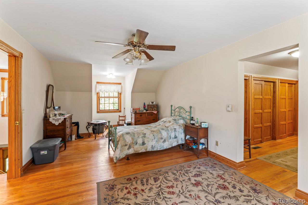 1591 Baldwin Road Lapeer, MI 48446 - Photo 20 of 46 Bedroom featuring light wood-style flooring, ceiling fan, and vaulted ceiling