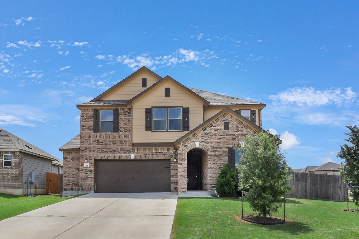 a front view of a house with a yard