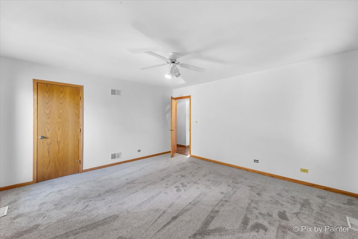 322 West Dowell Road McHenry, IL 60051 - Photo 15 of 40 an empty room with fan and windows