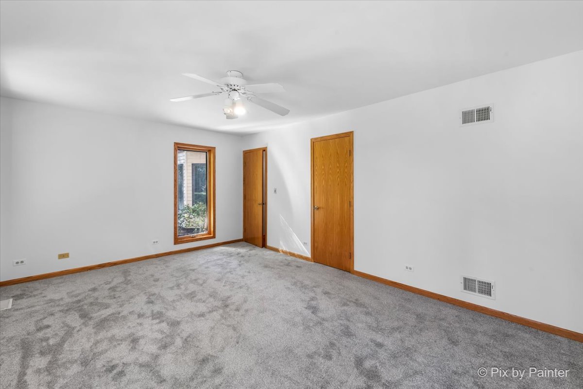 322 West Dowell Road McHenry, IL 60051 - Photo 17 of 40 an empty room with windows and chandelier fan