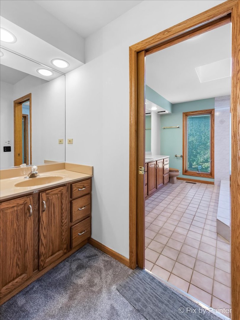 322 West Dowell Road McHenry, IL 60051 - Photo 21 of 40 a spacious bathroom with a vanity a mirror and a shower