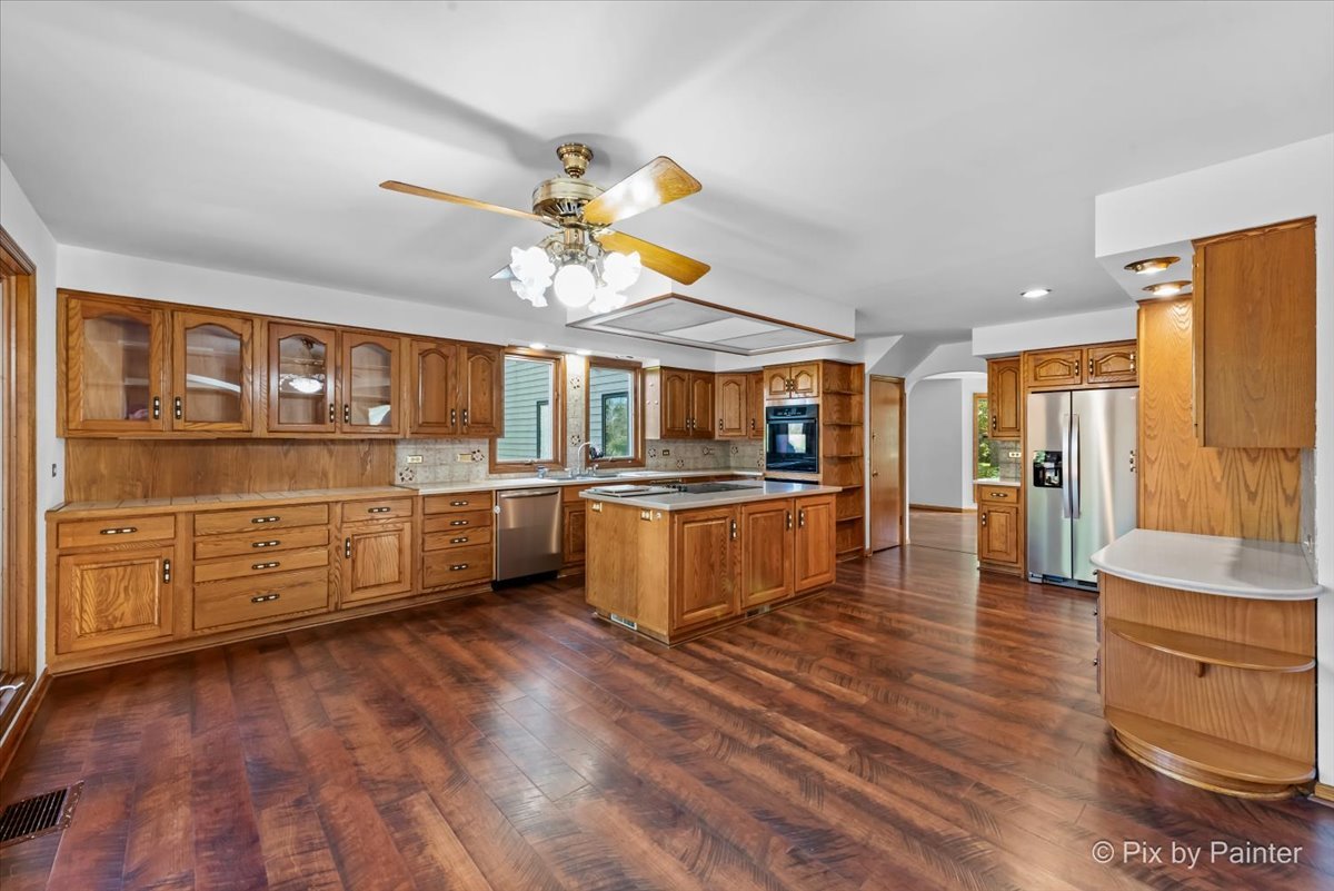 322 West Dowell Road McHenry, IL 60051 - Photo 4 of 40 a large kitchen with stainless steel appliances granite countertop a lot of counter space and wooden floors