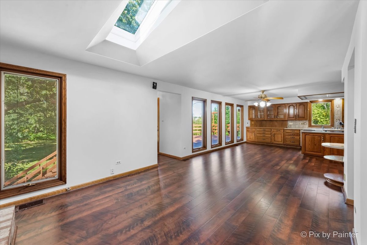 322 West Dowell Road McHenry, IL 60051 - Photo 7 of 40 a view of an empty room with wooden floor and a window