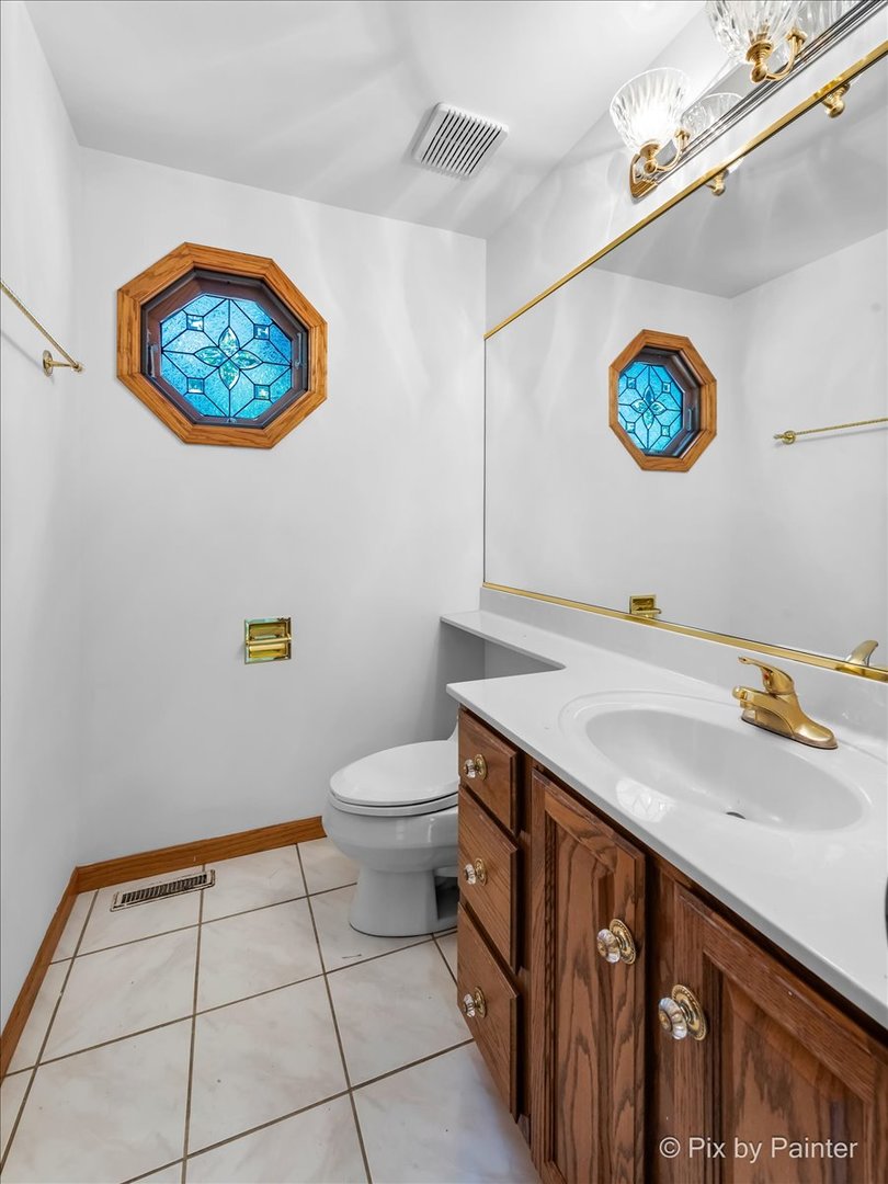 322 West Dowell Road McHenry, IL 60051 - Photo 10 of 40 a bathroom with a sink a vanity and a toilet