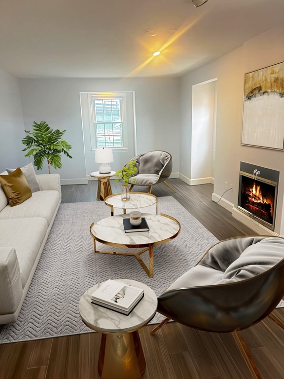 23 Chestnut Street, Unit 5 Chelsea, MA 02150 - Photo 2 of 17 a living room with furniture and a fireplace