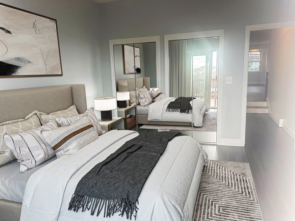 23 Chestnut Street, Unit 5 Chelsea, MA 02150 - Photo 5 of 17 a bedroom with bed and a couch