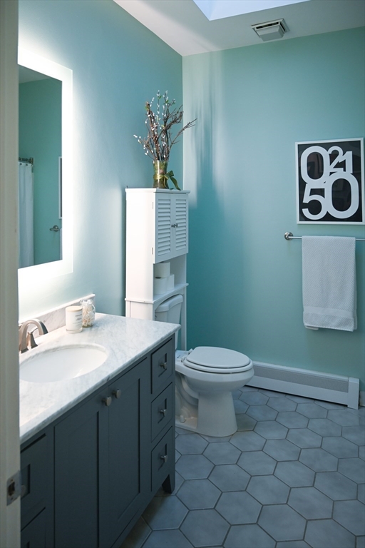 23 Chestnut Street, Unit 5 Chelsea, MA 02150 - Photo 8 of 17 a bathroom with a toilet sink and mirror